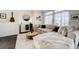 Comfortable living area with large windows, plush couch, and hardwood floors at 26293 E Archer Ave, Aurora, CO 80018