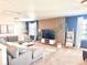 Stylish living room boasts a modern entertainment center and comfortable sectional sofa at 26293 E Archer Ave, Aurora, CO 80018