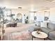 Bright living room featuring a cozy seating area and an inviting arched doorway at 26293 E Archer Ave, Aurora, CO 80018