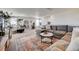 Cozy living room with gray sofa, decorative rug, and comfortable seating arrangement at 26293 E Archer Ave, Aurora, CO 80018
