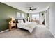 Spacious main bedroom with a ceiling fan, soft carpet, and a barn door to the en suite at 26293 E Archer Ave, Aurora, CO 80018