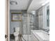 Bathroom featuring a walk-in shower with updated tile, toilet, and vanity at 5454 S Everett Ct, Littleton, CO 80123