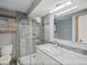 This renovated bathroom features a glass shower, updated vanity, and modern fixtures at 5454 S Everett Ct, Littleton, CO 80123