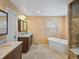 Bright bathroom featuring double vanity, soaking tub, natural light, and separate shower at 5454 S Everett Ct, Littleton, CO 80123