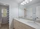 Bright bathroom with double sinks, marble countertop, and large mirror at 5454 S Everett Ct, Littleton, CO 80123