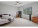 Bright bedroom with large window, carpeted floor, ceiling fan, and comfortable furniture at 5454 S Everett Ct, Littleton, CO 80123