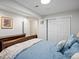 Bedroom featuring a comfortable bed, dresser, and a closet with sliding doors at 5454 S Everett Ct, Littleton, CO 80123