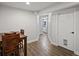 Dining area featuring wood table, seating, and view to bathroom at 5454 S Everett Ct, Littleton, CO 80123