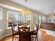 Bright dining area with views of the backyard, comfortable seating, and an adjacent living room for seamless entertainment at 5454 S Everett Ct, Littleton, CO 80123