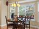 Inviting dining area featuring a round table, wooden chairs, and a bay window that brings in natural light at 5454 S Everett Ct, Littleton, CO 80123