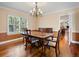 Formal dining room with hardwood floors, chandelier, and large window with shuttered blinds at 5454 S Everett Ct, Littleton, CO 80123
