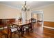 Dining room featuring hardwood floors, chandelier, and open access to other rooms at 5454 S Everett Ct, Littleton, CO 80123