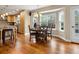 Dining area with hardwood floors, bay windows, and an adjacent kitchen space at 5454 S Everett Ct, Littleton, CO 80123