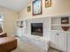 Living room fireplace with a white brick hearth and built-in shelving at 5454 S Everett Ct, Littleton, CO 80123