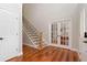 Bright foyer features a staircase, beautiful hardwood floors, and french doors leading to an office or den at 5454 S Everett Ct, Littleton, CO 80123