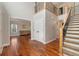 Inviting foyer with hardwood floors, staircase with iron railings, and an adjacent living room at 5454 S Everett Ct, Littleton, CO 80123