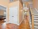 Inviting foyer with hardwood floors, a staircase with iron spindles, and a view of the living spaces at 5454 S Everett Ct, Littleton, CO 80123