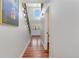 Hallway features gleaming hardwood floors, access to the upper and lower levels and a stunning entry way with double doors at 5454 S Everett Ct, Littleton, CO 80123