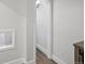 Neutral hallway leads to a bright, well-lit space with modern flooring and neutral walls at 5454 S Everett Ct, Littleton, CO 80123