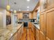 Well-equipped kitchen featuring wood cabinetry, granite countertops, stainless steel appliances, and hardwood floors at 5454 S Everett Ct, Littleton, CO 80123