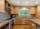 Eat-in kitchen with stainless steel appliances, mosaic backsplash, hardwood floors and natural light at 5454 S Everett Ct, Littleton, CO 80123