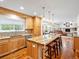 Open kitchen featuring an island with seating, a breakfast nook, and backyard views at 5454 S Everett Ct, Littleton, CO 80123