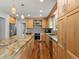 Bright kitchen with stainless steel appliances, wood cabinets, granite counters, and hardwood floors at 5454 S Everett Ct, Littleton, CO 80123