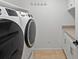 Modern laundry room with a large washer and dryer and cabinetry for storage, making chores convenient at 5454 S Everett Ct, Littleton, CO 80123