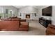 Spacious living room with brick fireplace, vaulted ceiling, and ample natural light at 5454 S Everett Ct, Littleton, CO 80123