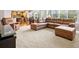 Inviting living room featuring an open floor plan, a leather sectional sofa and carpet at 5454 S Everett Ct, Littleton, CO 80123
