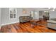 Bright living room featuring wood floors, neutral walls, shuttered windows and dining room access at 5454 S Everett Ct, Littleton, CO 80123