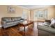 Spacious living room with hardwood floors, comfortable sofas, and a large bay window at 5454 S Everett Ct, Littleton, CO 80123