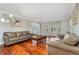 Comfortable living room showcasing wood floors, bay windows with shutters, neutral walls and sofas at 5454 S Everett Ct, Littleton, CO 80123