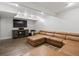 Cozy living room with large sectional sofa, wood floors, and entertainment center at 5454 S Everett Ct, Littleton, CO 80123