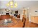 Open floor plan connecting dining area to a spacious living room with a fireplace and built-in shelves at 5454 S Everett Ct, Littleton, CO 80123
