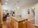 Open concept kitchen with a large island and modern appliances seamlessly connecting to the living room and dining space at 5454 S Everett Ct, Littleton, CO 80123