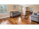 Open concept living room with hardwood floors, natural light, and seamless flow to dining area at 5454 S Everett Ct, Littleton, CO 80123