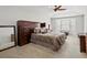Spacious main bedroom with vaulted ceiling, large bed, dark wood storage, and bay window at 5454 S Everett Ct, Littleton, CO 80123