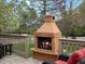 Close-up of a charming outdoor fireplace on the patio, creating a cozy ambiance at 5454 S Everett Ct, Littleton, CO 80123