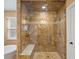 Spacious shower with dual shower heads, bench seat, and glass enclosure at 5454 S Everett Ct, Littleton, CO 80123