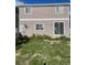 Exterior view of the home featuring an air conditioning unit and sliding glass doors to the yard at 5537 Malta St, Denver, CO 80249