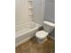 Bathroom featuring a white tiled shower and tub combination with a toilet at 5537 Malta St, Denver, CO 80249