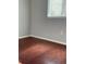 Empty bedroom with hardwood floors and natural light coming in through the window with modern blinds at 5537 Malta St, Denver, CO 80249