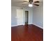Bedroom with ceiling fan, wood floors, closet and neutral-toned walls at 5537 Malta St, Denver, CO 80249