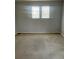 Empty bedroom features neutral carpeting and natural light streaming through the two large windows at 5537 Malta St, Denver, CO 80249