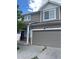 Two-story home with neutral siding, stone accents, and a two-car garage at 5537 Malta St, Denver, CO 80249