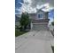 Two-story home featuring neutral siding, stone accents, and an attached two-car garage at 5537 Malta St, Denver, CO 80249