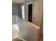 Upstairs hallway featuring access to bathroom and bedrooms with carpeted stairs at 5537 Malta St, Denver, CO 80249