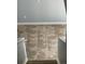 Hallway with tiled flooring and a view of the staircase and a partial view of the carpeted stairs at 5537 Malta St, Denver, CO 80249