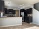 Kitchen boasts dark cabinets, stainless steel appliances, and a breakfast bar at 5537 Malta St, Denver, CO 80249